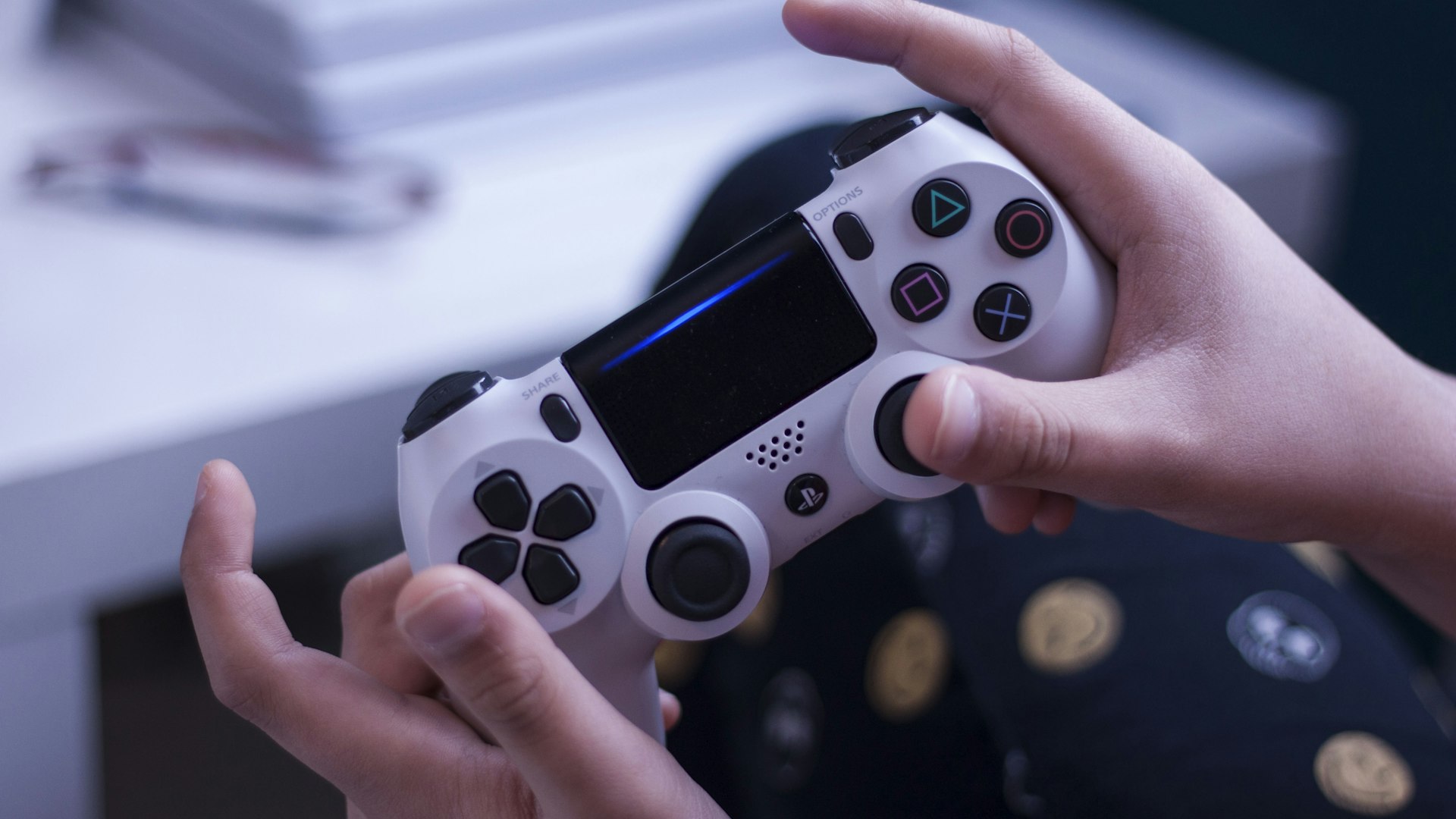 A darkened editorial workspace with monitors displaying gameplay footage